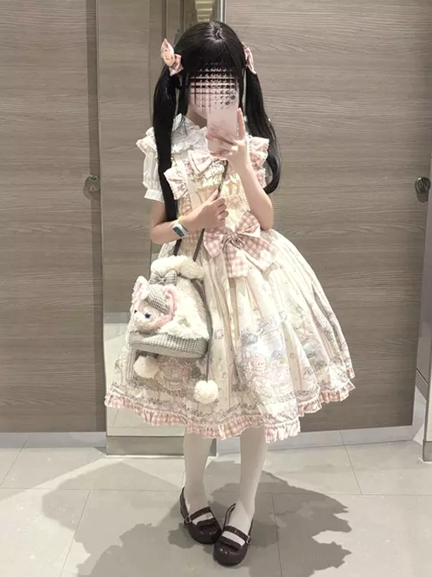 Pink cream sweet lolita dress with coordinating hair bows and Mary Jane brown shoes worn with white stockings and blue wristband accessory