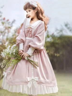 Pink sweet lolita dress three-quarter view with sailor collar and ruffled lace hem worn by model in flower garden setting