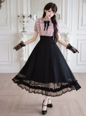 Vintage-inspired pink black lolita midi dress featuring white ruffled top, black gloves, Mary Jane heels, and signature bow detail on model