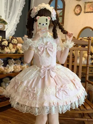 Pink and white sweet lolita dress with oversized bow, worn from back angle by model with twin tails in vintage doll room setting, showcasing lace-trimmed skirt and ruffled short sleeves