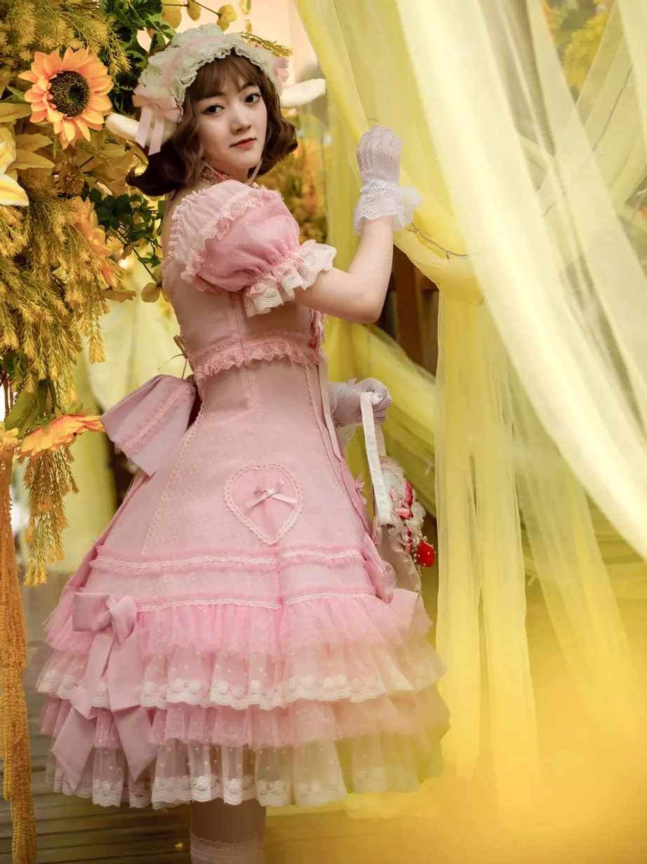 Sweet Lolita dress rear three-quarter view showing puff sleeves ruffled back details and matching handheld bag