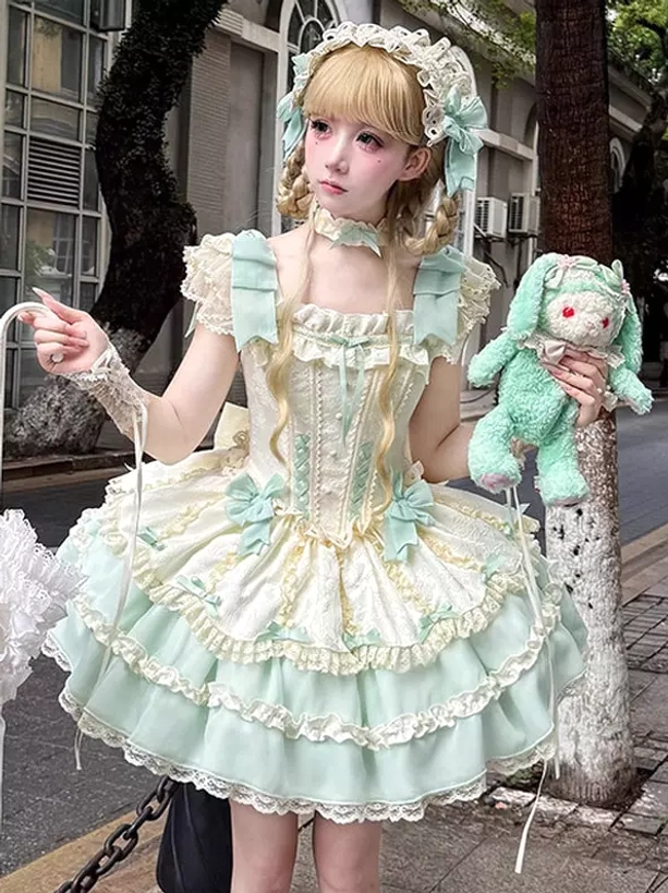 Mint green sweet lolita dress with bow-decorated ruffled shoulders, lace-up bodice details, model holding mint green plush rabbit accessory with matching hairpiece in urban outdoor street setting