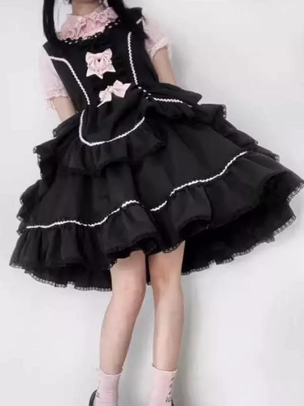 Close-up detail of layered ruffled skirt with white lace trim and pink bow decorations on Sweet Lolita dress