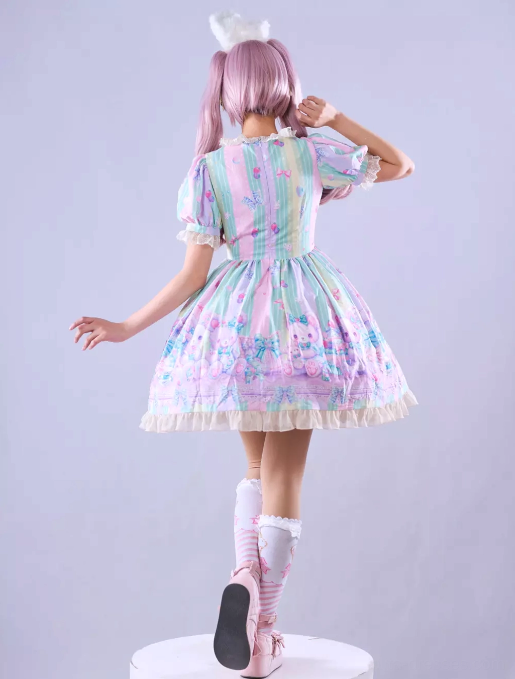 Sweet lolita dress layered ruffles and embellishment detail showing multiple layers of lace, ruffles, and decorative elements creating dimensional texture