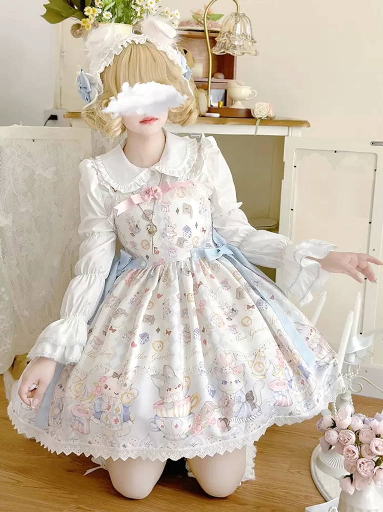 Front kneeling shot of sleeveless sweet lolita jumper dress with scalloped lace hem pink front bow and long ruffled blouse