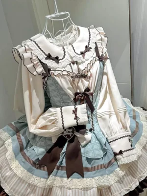 Light sky blue lolita dress set angled front perspective showing heart-shaped hanging tag cuff detail and prominent waist bow accent