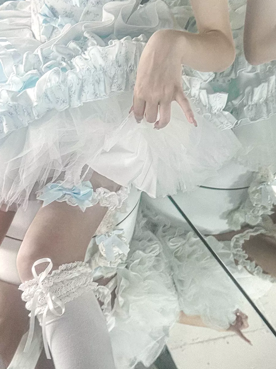 Sweet lolita dress skirt close-up lower body details showing ruffled tulle layers blue bow garter lace frill socks coordinate styling