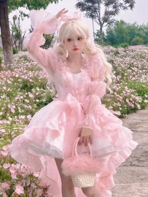 Sweet pink lolita dress three-quarter angle showing high-low ruffled skirt construction, elasticated sleeve cuffs, fluffy pink woven handbag accessory coordination