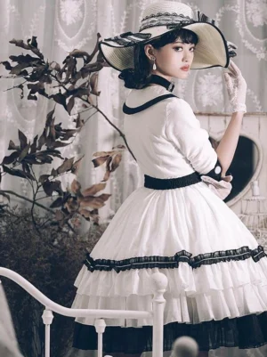 Sweet lolita dress side back view outdoors in garden, model wearing wide brim bonnet and white bow belt, demonstrating the elegant profile and drape of the three-quarter sleeve ruffle dress