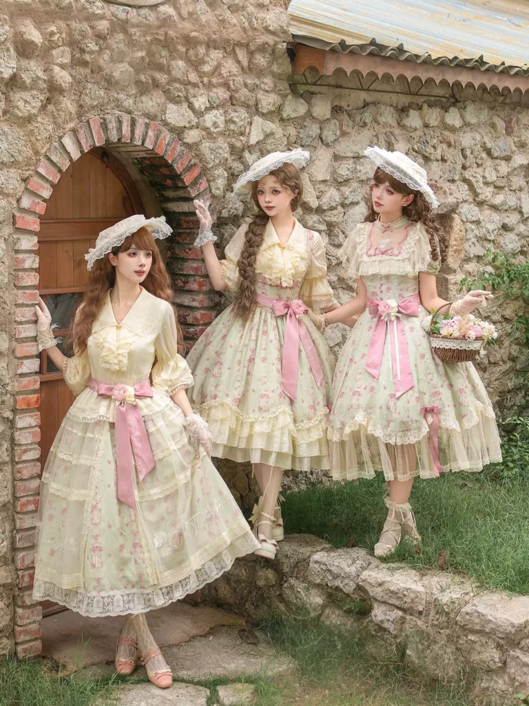 Detail view of pink floral sweet lolita dress showing tulle construction, ribbon trim, ruffled details and delicate fabric layering