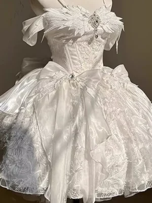 Close-up front detail of white lolita formal gown showing corset lace bodice, rhinestone waist bow, and embroidered tulle flare skirt, sweet lolita dress details
