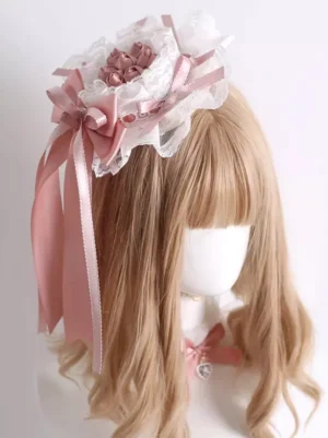 Sweet lolita dusty pink mini top hat hair clip with layered white lace and satin bows shown on mannequin left front three-quarter view