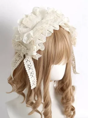 Ecru white sweet lolita lace hairband with flowing ribbon streamers and ornate bow, side profile view showing layered ruffled construction and detailed floral lace embellishment, worn on mannequin with brown curly hair