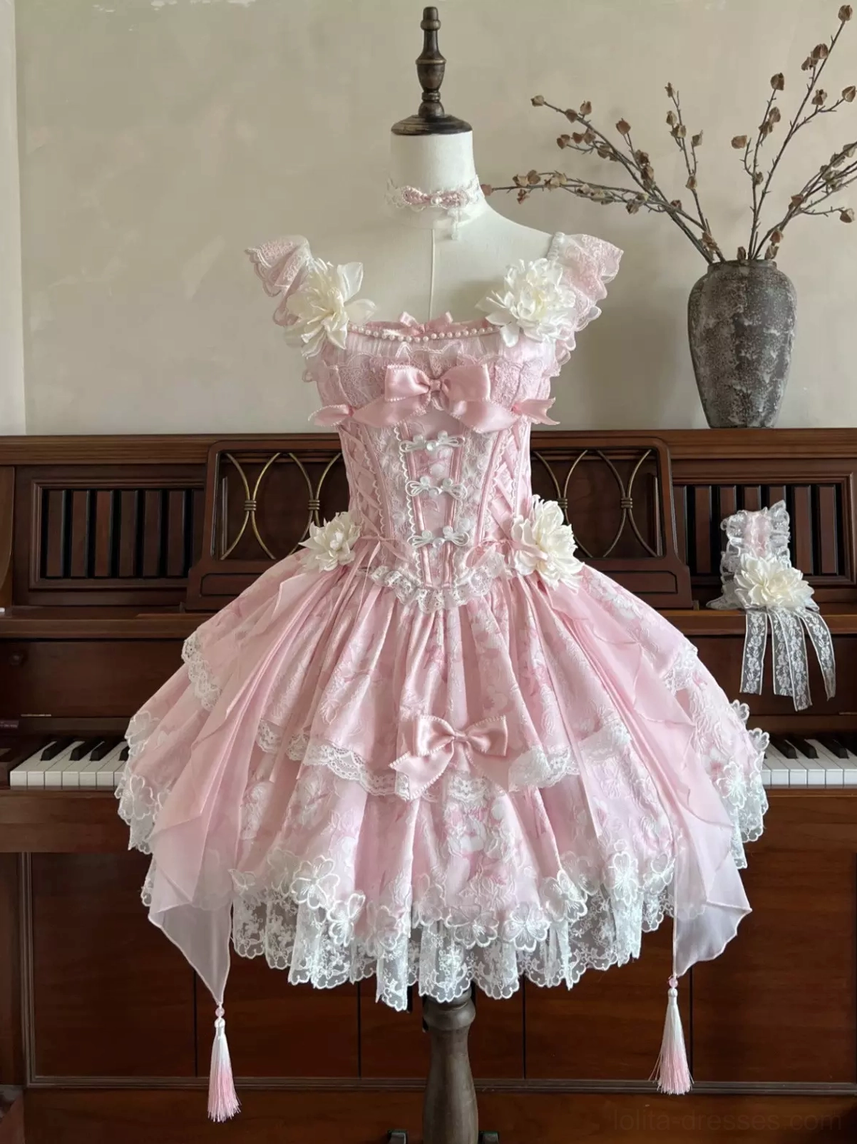 Enchanted garden sweet lolita fairy dress detail shot highlighting intricate floral lace corset bodice bone structure and bow accents