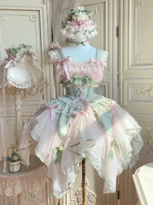 Sweet Lolita fairy dress in pink and green with layered ruffles, lace-up corset waist, and handkerchief hem tulle skirt front view on dress mannequin