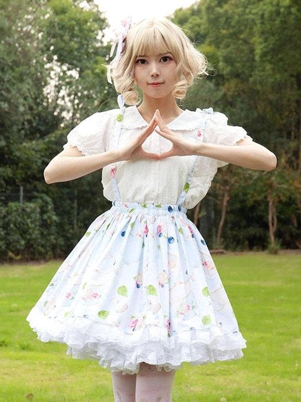 Sweet lolita floral print skirt with white ruffle hem and doll collar blouse worn outdoors on blonde model with hair accessory front view
