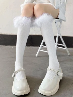 white fluffy trim knee high lolita socks front low angle view sweet fashion ribbed knit with feather cuff paired with white patent mary jane shoes