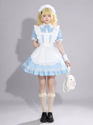 French maid style lolita dress full body side profile showing ruffled hem, white wrist cuffs, beige lace socks, black loafers, and complete ensemble styling with accessories