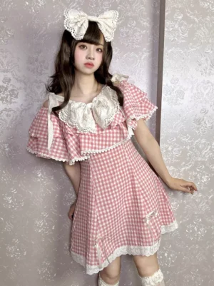 Pink gingham Sweet Lolita mini dress full front view with layered ruffle collar large white bow hair accessory detailed lace hem trim