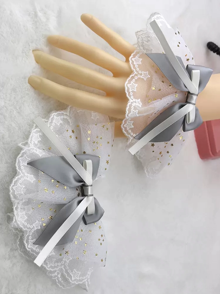 Grey satin hair bow paired with white ruffled mesh wrist cuffs adorned with gold star details and scalloped lace trim, Sweet Lolita accessory ensemble
