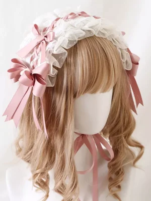 Sweet lolita headdress oblique side view showing multiple layers of pink satin bows and delicate white ruffled lace detailing on curly hair mannequin