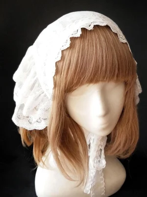 Three-quarter front angle of white ruffled lolita bonnet headdress showing tiered lace layers and attached neck ribbon