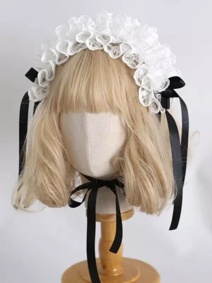Sweet Lolita lace headdress with black and white satin ribbon bows, featuring delicate ruffled white lace construction displayed on mannequin with blonde bob wig