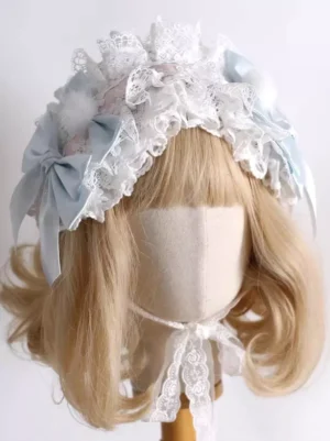 Sweet Lolita white lace headdress with light blue satin bows and fluffy white pom-poms, front oblique view on mannequin with blonde wig