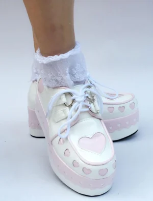 Sweet Lolita heart platform shoes three-quarter side view showing thick block platform sole lace-up closure and heart decorations with white ruffled socks
