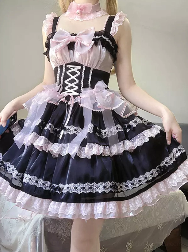 Sweet lolita JSK dress in black-pink color scheme, front half-body view showing corset lace-up bodice, ruffled tiered skirt, soft aesthetic styling