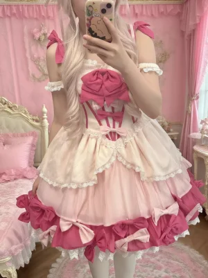 Sweet Lolita Jumper Skirt dress selfie front view showing corset-style bodice with bow straps and off-shoulder design details, model holding smartphone in romantic bedroom scene