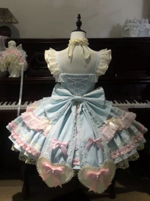Rear view of pastel blue sweet lolita dress showing lace-up corset back oversized pink bow heart-shaped hem accents tiered ruffles piano background