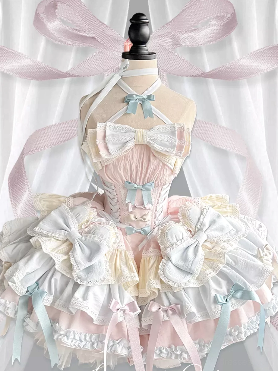 Sweet Lolita JSK dress form three-quarter front view corset bodice multi-layered frills blue bow accents pink ribbon backdrop full ensemble