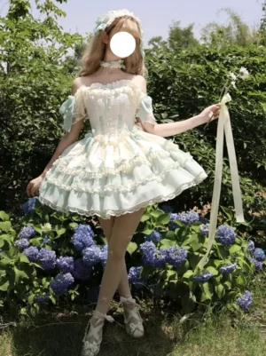 Sweet lolita jumper skirt dress with short off-shoulder sleeves and flowing ribbons, full body side view showcasing layered ruffle skirt and mini length in hydrangea garden