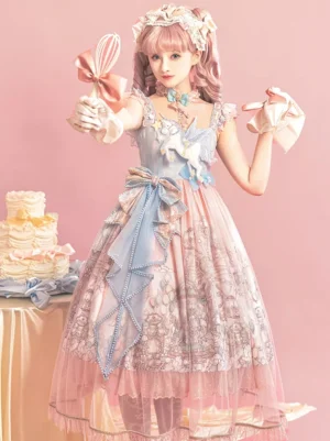 Pastel pink and blue sweet lolita jsk dress with tiered ruffles and large satin waist bow on studio background with dessert table styling