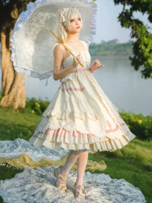 Back three-quarter perspective of cream sweet Lolita sleeveless dress showing layered tiered ruffled skirt, pink waist decorations, and intricate hem details at lakeside setting