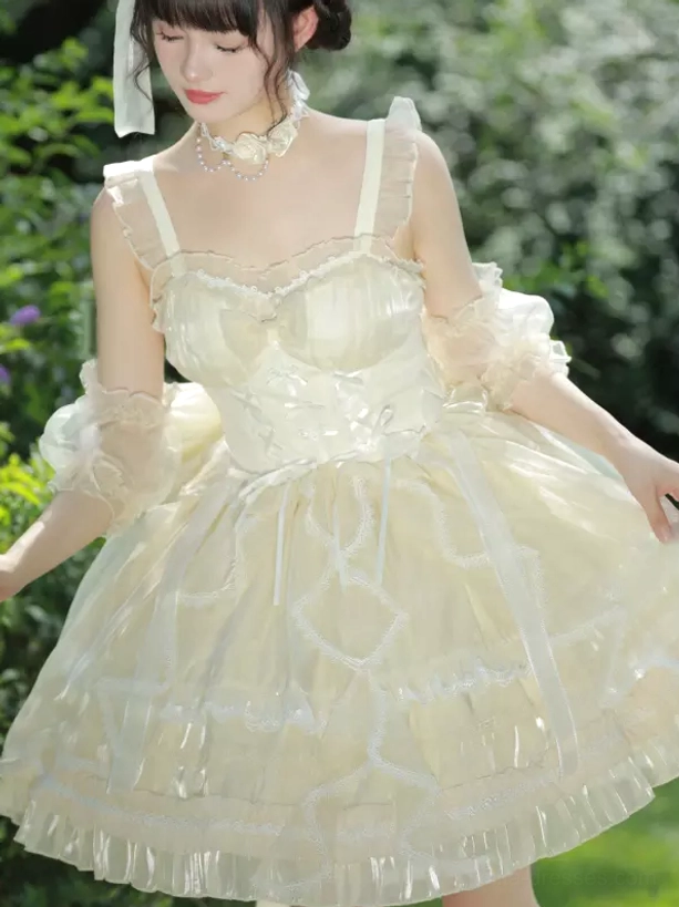Ivory sweet lolita JSK dress front side angle worn by model with sheer arm cuffs, lace choker, ruffled tulle skirt in garden setting