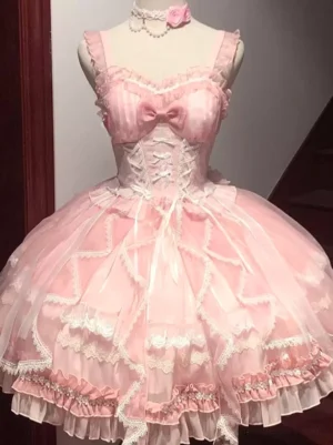 Pink sweet lolita JSK dress with embroidered bodice, chest bow, corset waist, layered tulle skirt, and ruffled lace hem displayed on mannequin front view