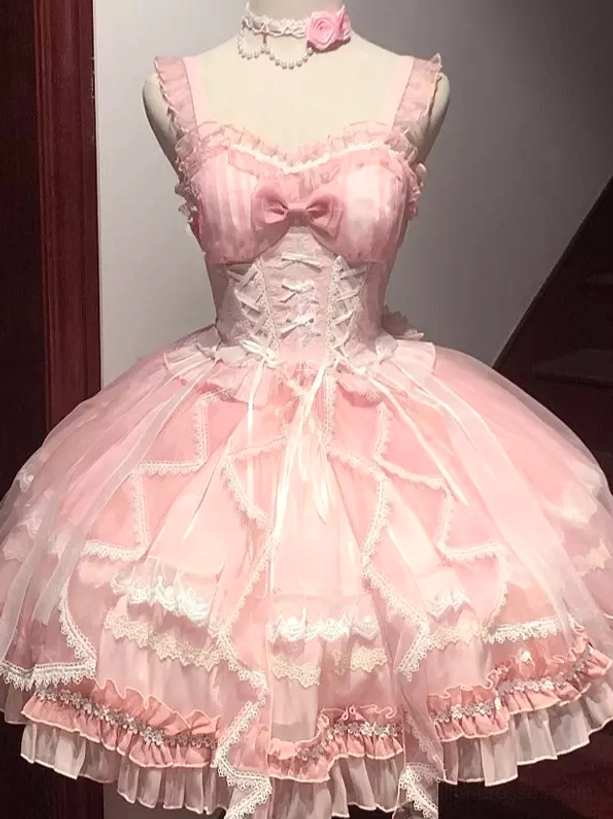 Pink sweet lolita JSK dress with embroidered bodice, chest bow, corset waist, layered tulle skirt, and ruffled lace hem displayed on mannequin front view
