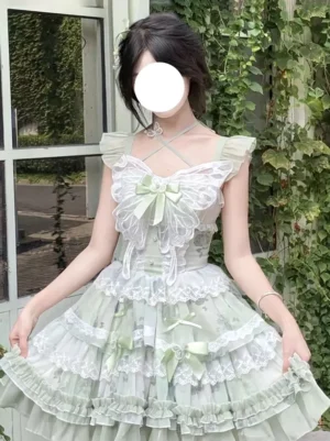Sweet Lolita JSK dress sage green floral print close-up front view displaying cross halter straps, lace butterfly chest decoration, and layered lace trim details