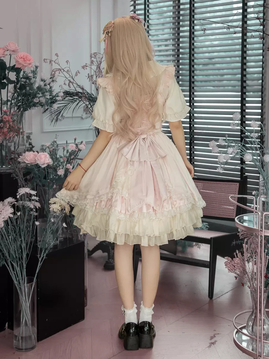 Seated side view sweet lolita dress elegant sitting pose cafe indoor scene ruffled skirt hem pink wig model