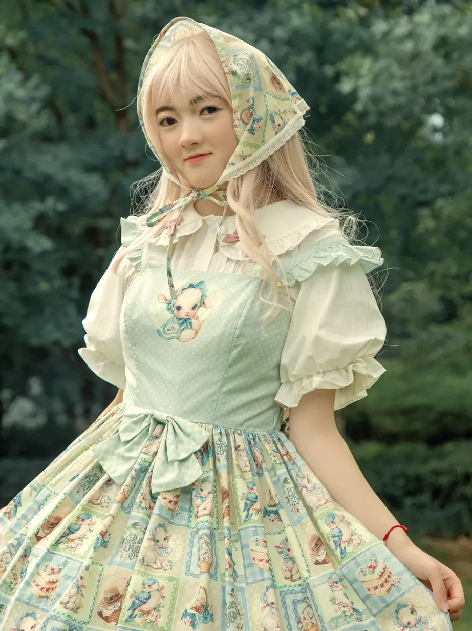 Three-quarter front view of sweet lolita dress in woodland setting with matching printed headscarf, sheer puff sleeve blouse, small chest embroidery, waist bow detail