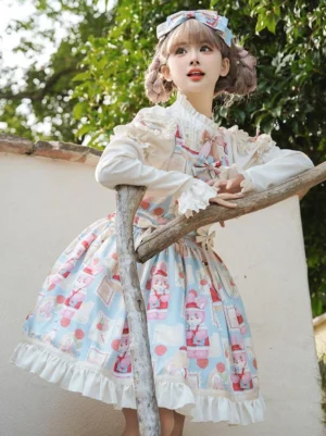 Light sky blue Sweet Lolita sleeveless jumper dress with cartoon print design and ruffled hem, worn outdoors in garden setting with matching hair bow