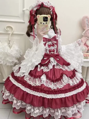 Wine red and white sweet lolita sleeveless jumper dress with layered ruffles and lace trims, worn with matching hair accessory and red mary jane shoes