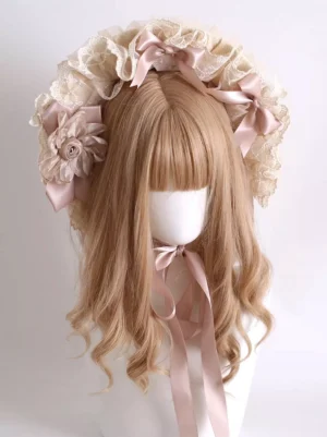 Back top-down view of lace bonnet headdress displaying multiple pink satin bows and fabric flowers decoration