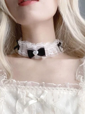 Lolita lace choker with decorative side clips and heart pearl detail worn on lower neck and chin area close-up