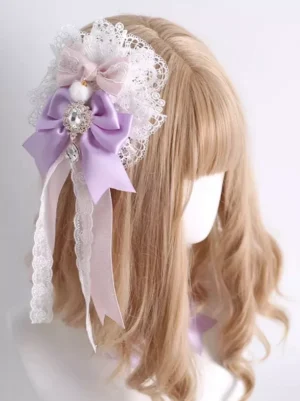 Three-quarter back angle of lavender lolita hair clip showing rhinestone details white pompom and mixed satin lace ribbon design on blonde bob wig