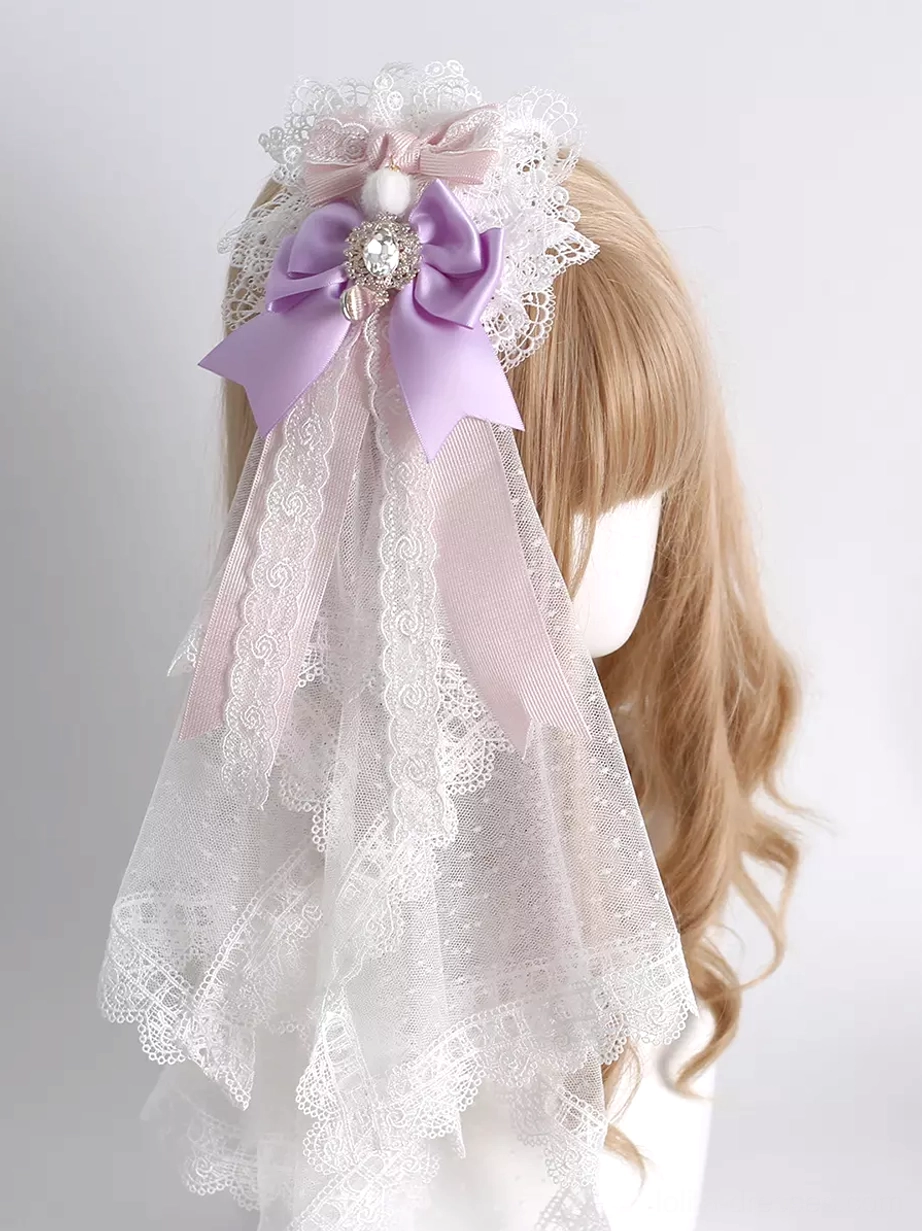 Sweet lolita lavender hair clip with satin bow and layered tulle veil featuring lace trim and rhinestone accents, displayed on mannequin with curly blonde hair, rear left side view showing detailed construction