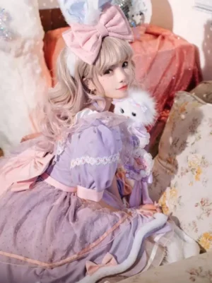 Lavender lolita dress side three-quarter view showing lace sleeve trim, dotted tulle skirt layers, waist bow, and delicate construction details