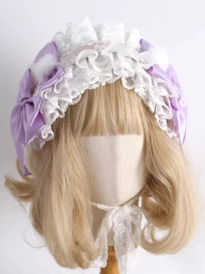 Sweet lolita lavender lace headband with purple satin bows and white fluffy pom-poms front flat lay view on blonde wig mannequin